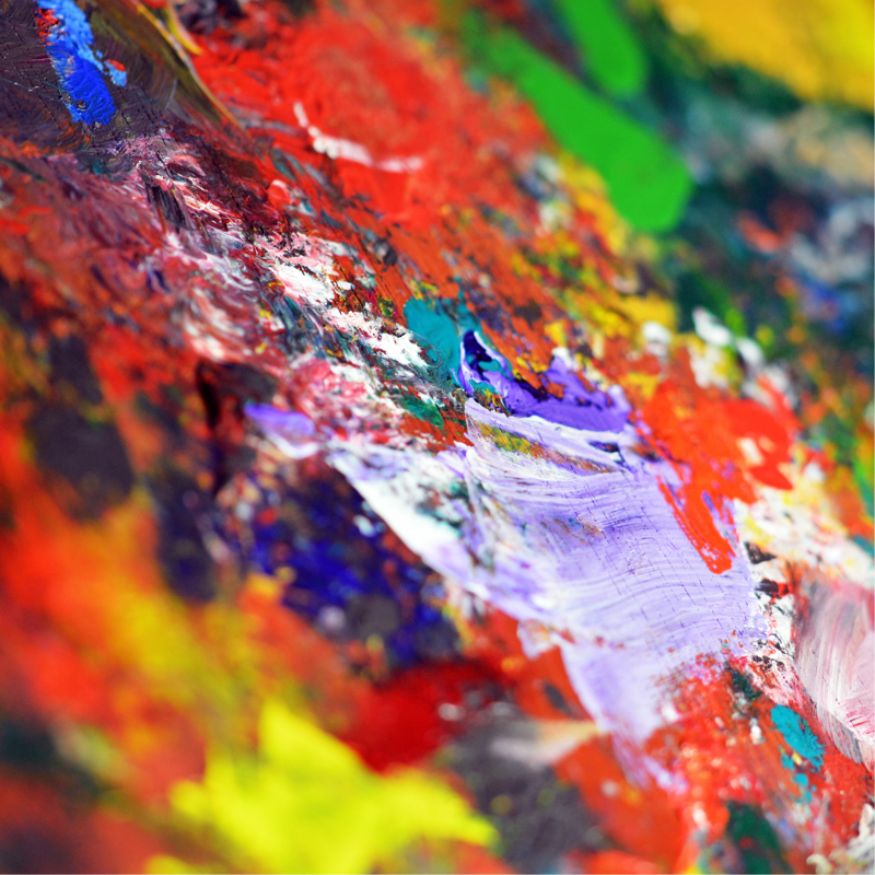 zoomed in on colorful thick paint abstractly smeared on canvas